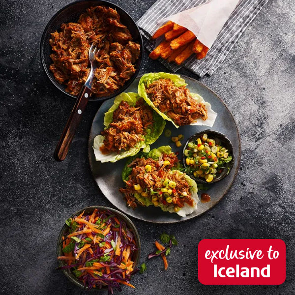 Slimming World food range barbecue pulled pork served in lettuce cups on a grey plate with coleslaw and sweet potato fries on the side. Red box with text reading 'exclusive to Iceland'