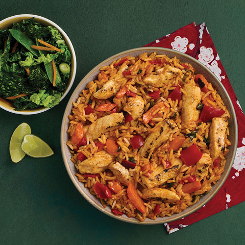 Bowl of Slimming World Korean-style chicken and rice served with green vegetables