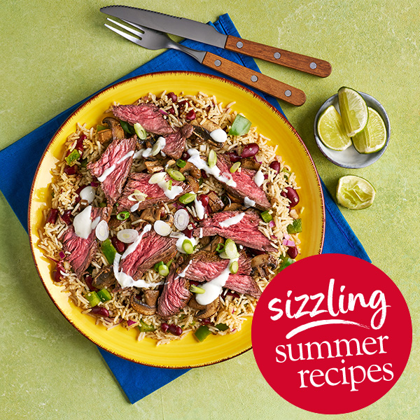 Slimming World Kitchen's Jerk steak with rice and peas. A red circle containing the text 'Sizzling summer recipes' sits in the bottom left corner.