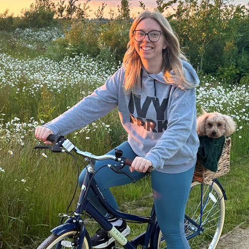 Slimming World member riding a bike with a dog in the basket