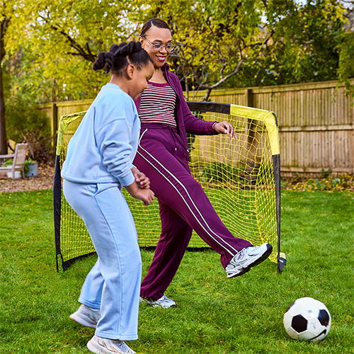 member Devina Carby with her daughter playing football